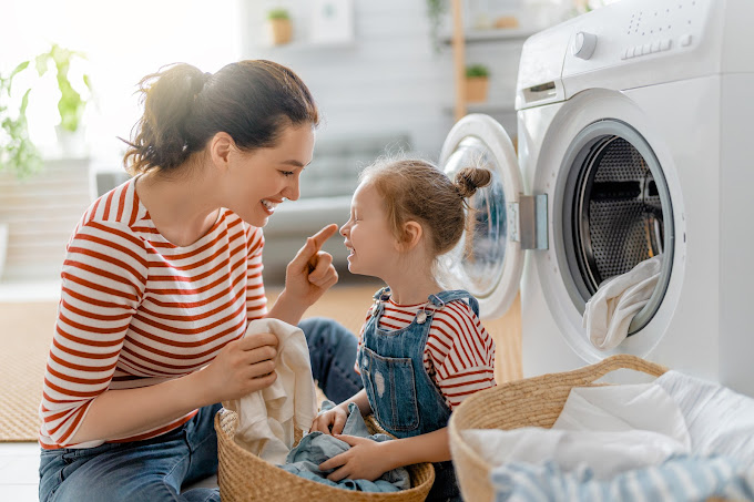 Mother and daughter doing laundry